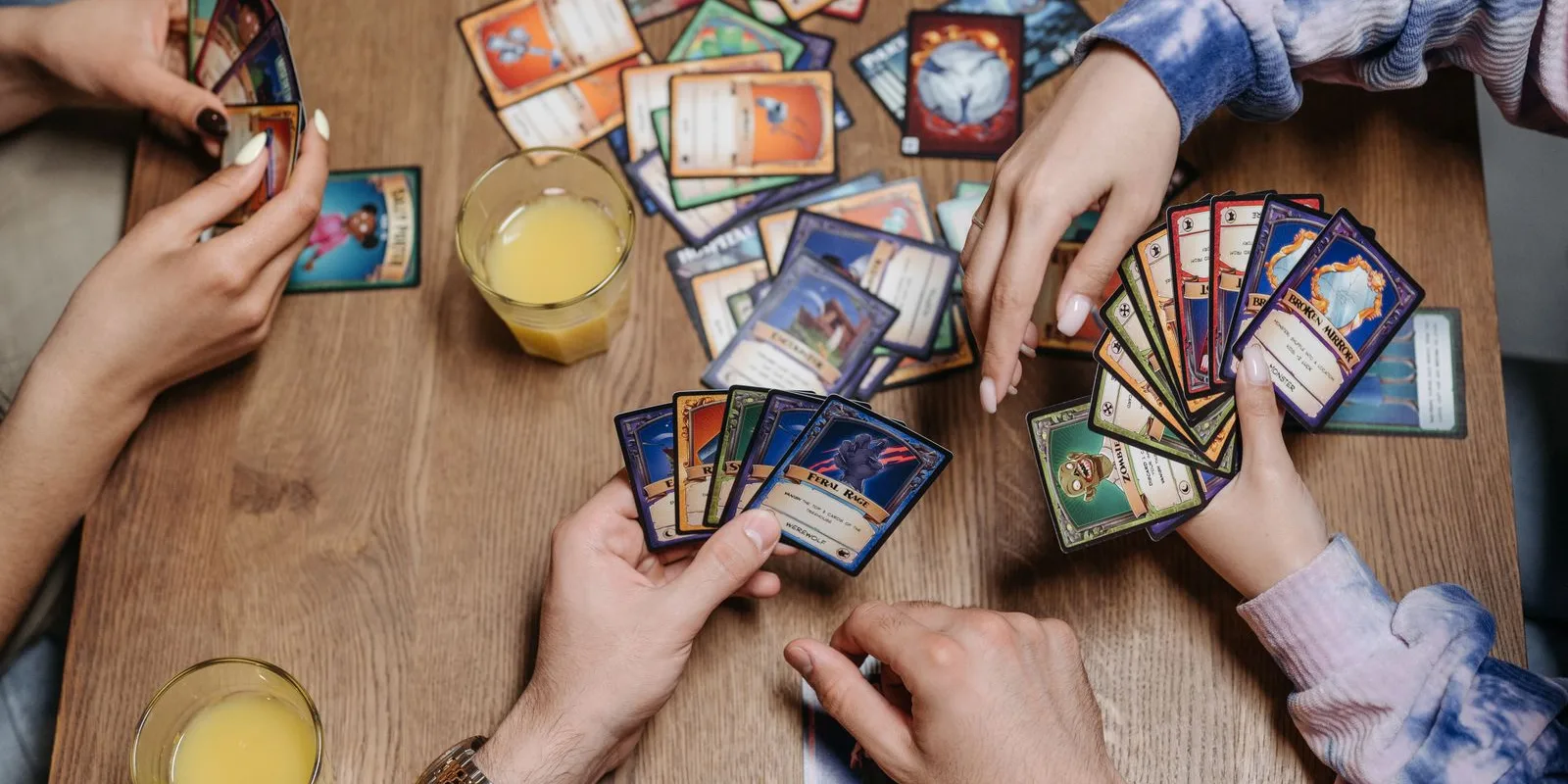 Friends playtesting a card game together around a table