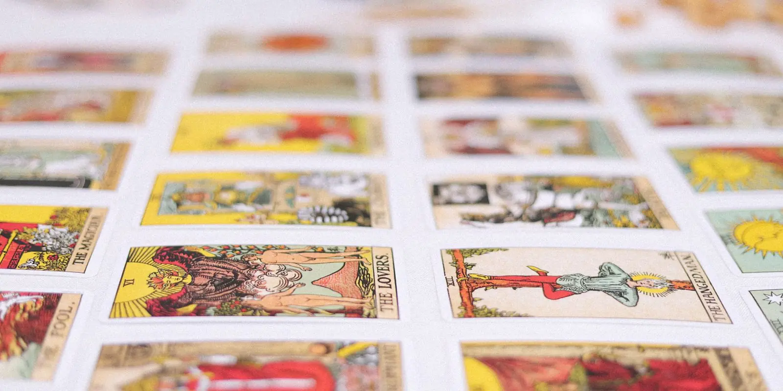 A full set of illustrated cards laid out face up in a grid on a white surface